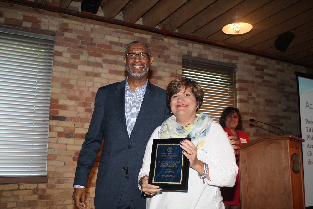 Mrs. Rita Cooper receiving the Professional Support Staff accomodation from Dean Grant